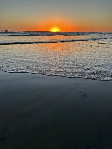 A photo of a setting sun over the Pacific Ocean.